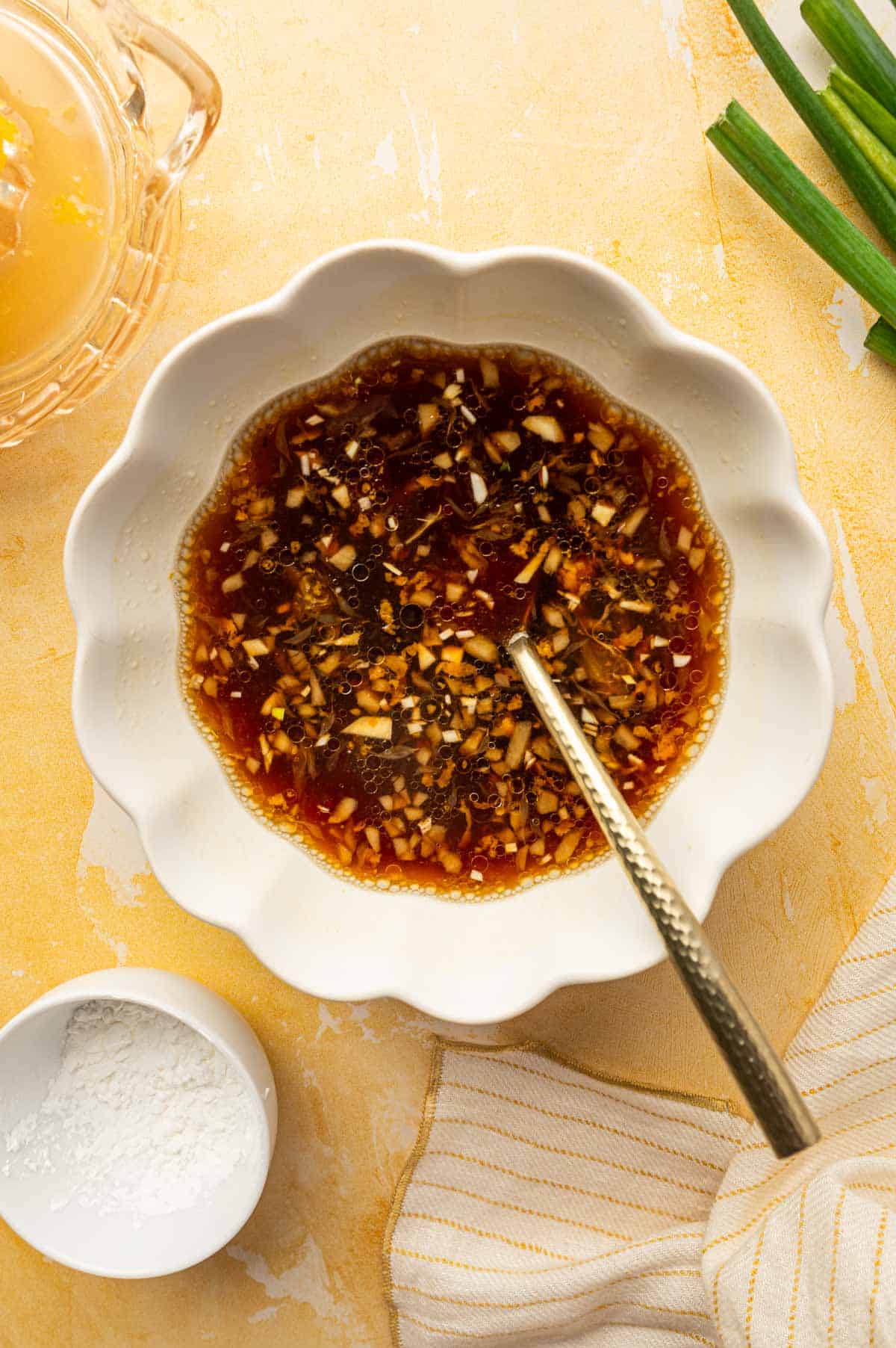 In a bowl orange sauce ingredients being mixed.