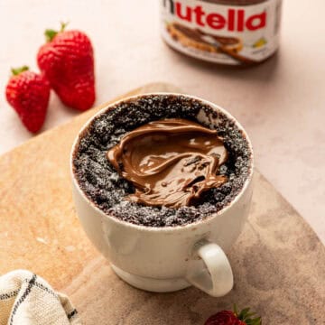 Chocolate Nutella mug cake in a mug with gooey middle, quick microwave dessert.