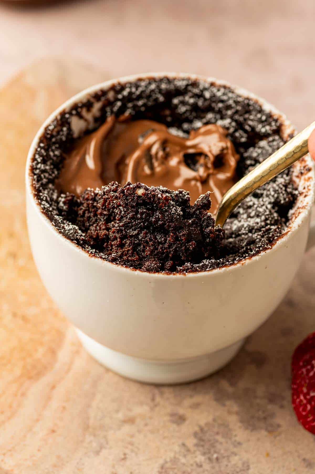 Close-up of moist Nutella mug cake crumb inside a mug