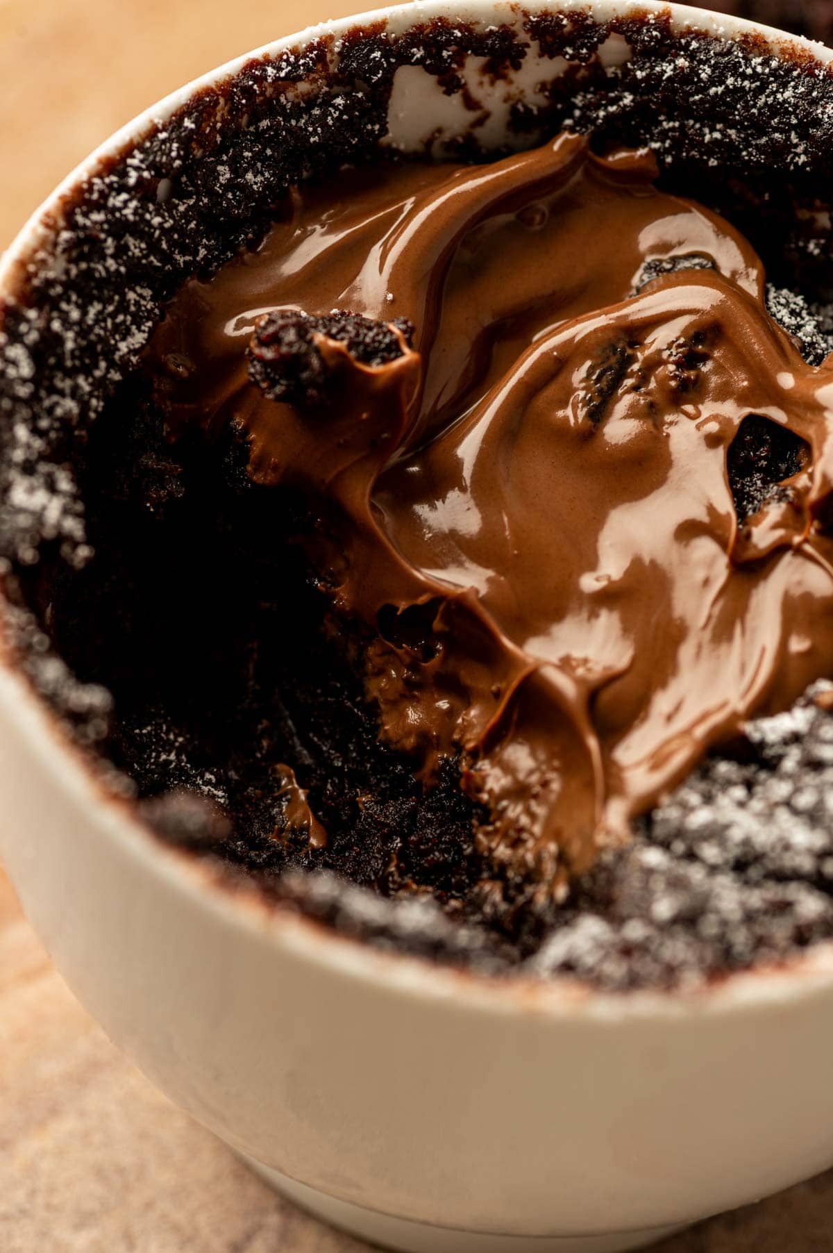 Bite of chocolate Nutella mug cake inside texture with molten center, microwave dessert