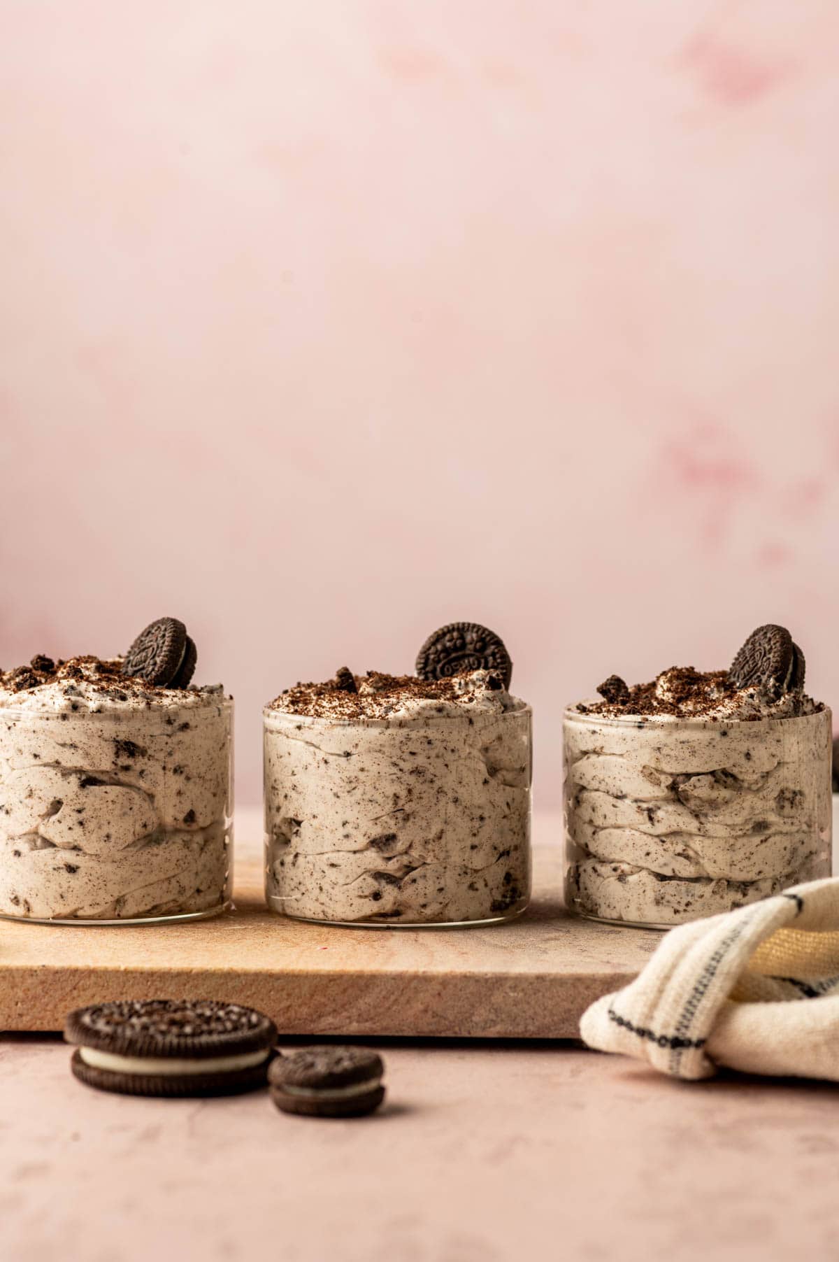 Oreo mousse cups with layered cookies and cream filling in a glass jars.