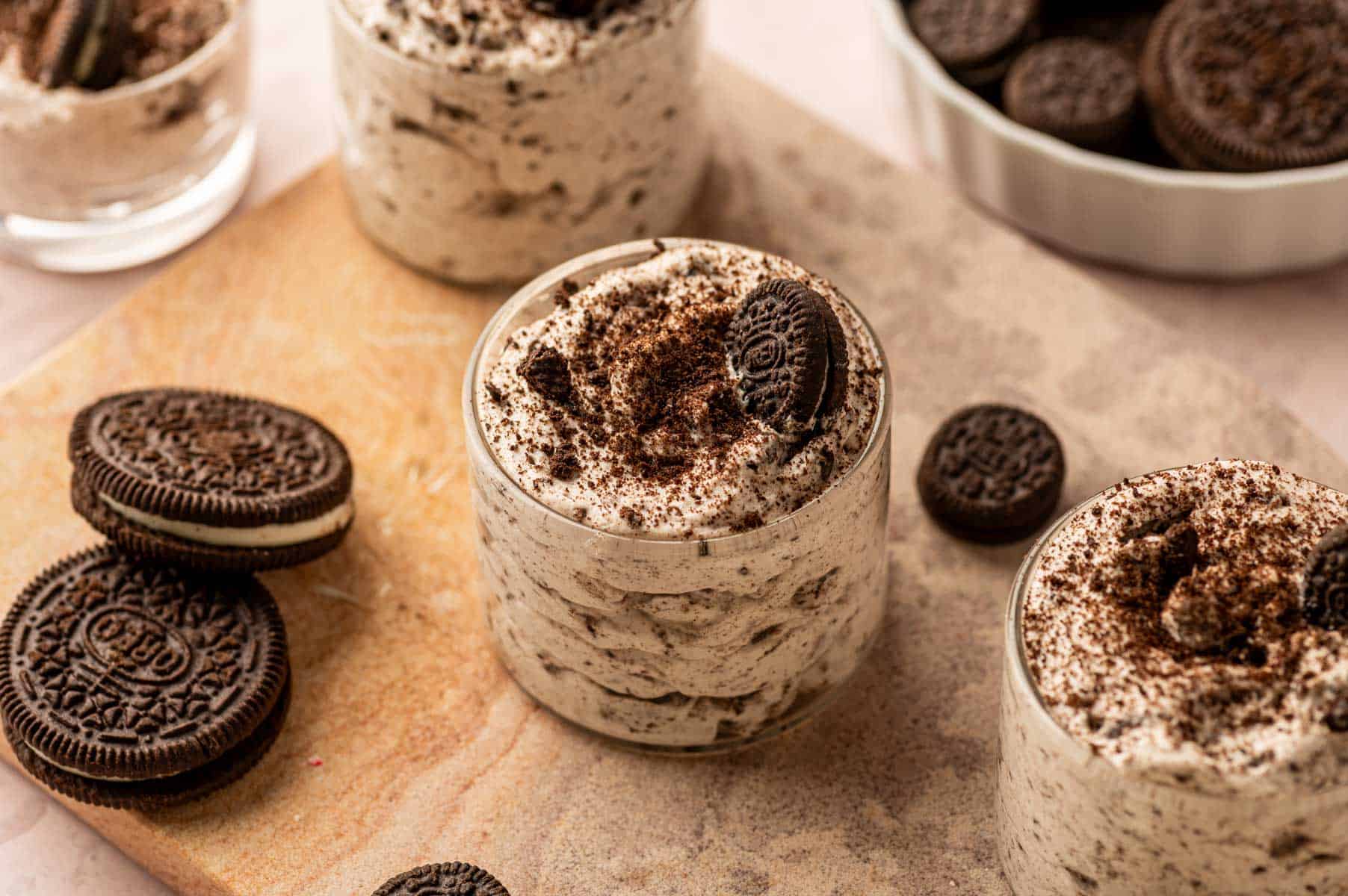 No-bake Oreo cookies and cream mousse served in dessert cups and some double stuf oreos around.