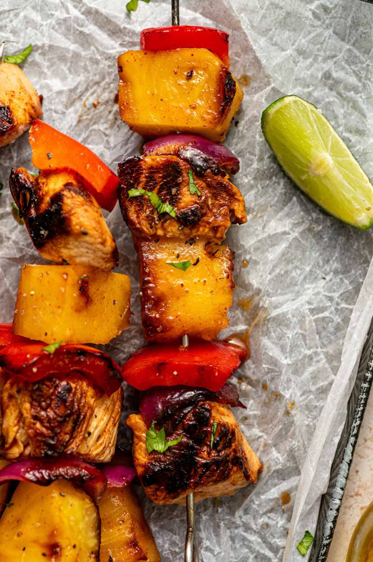 Close-up of grilled pineapple chicken kabobs showing caramelized chicken
