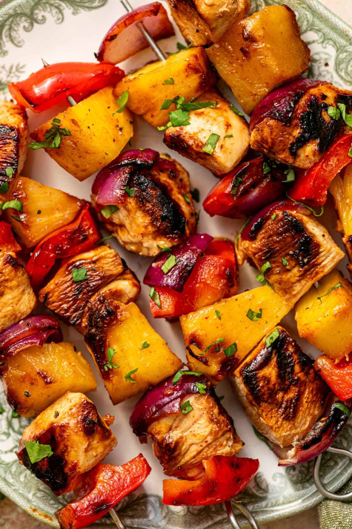 Close-up of grilled pineapple chicken kabobs showing caramelized chicken