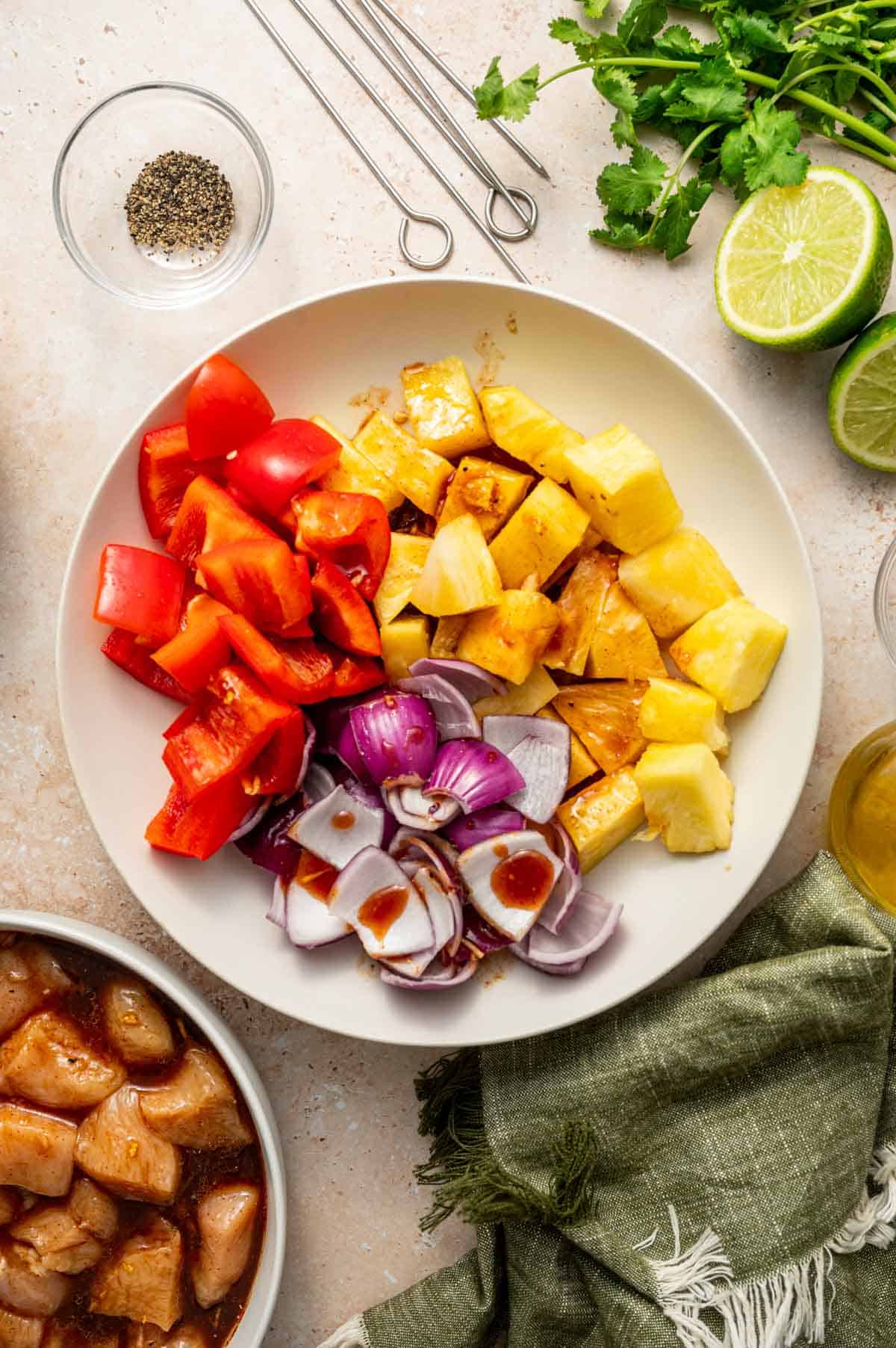 Reserved marination being added for pineapple, onions and red bell pepper.