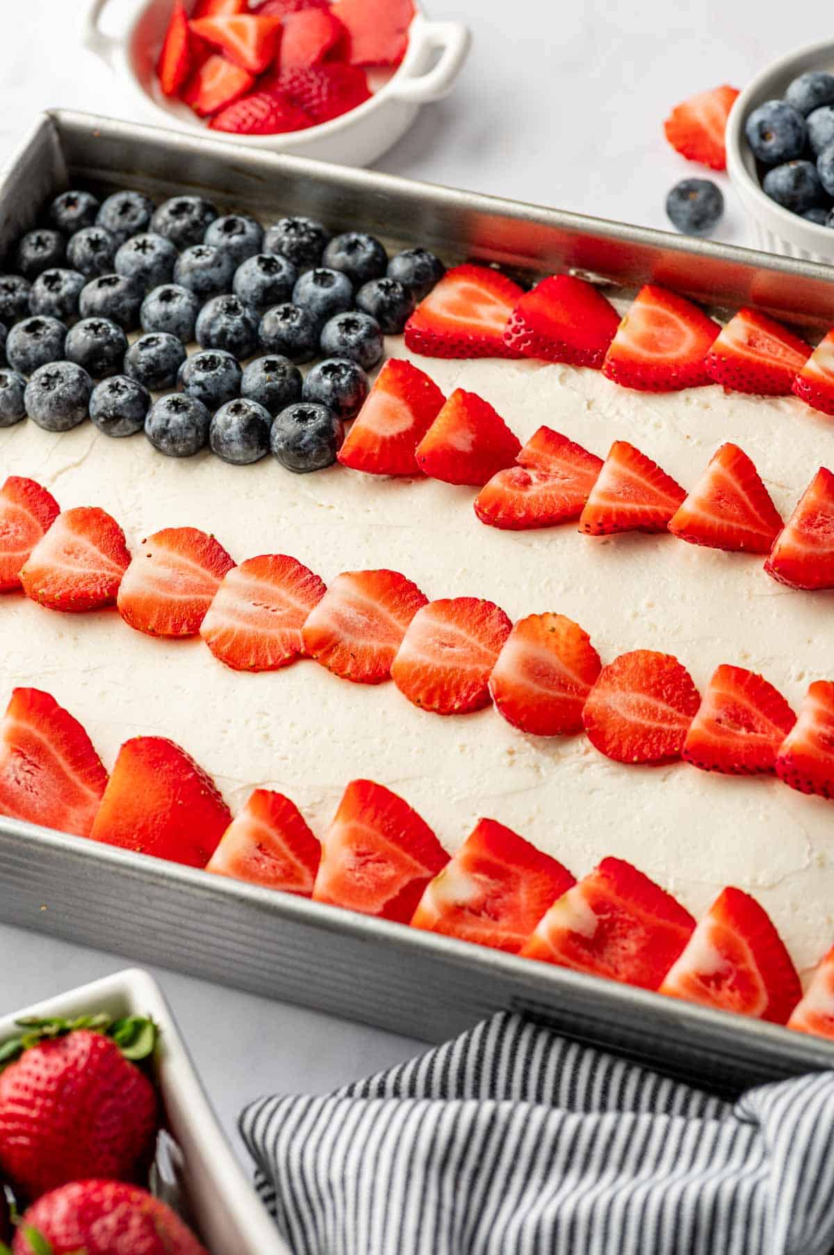 Vanilla sheet cake with buttercream frosting and patriotic fruit flag design