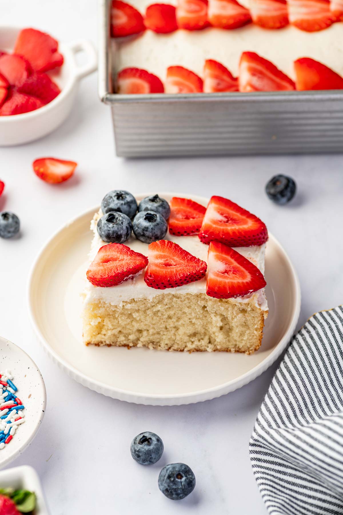 Sliced flag cake showing fluffy vanilla sheet cake and buttercream frosting