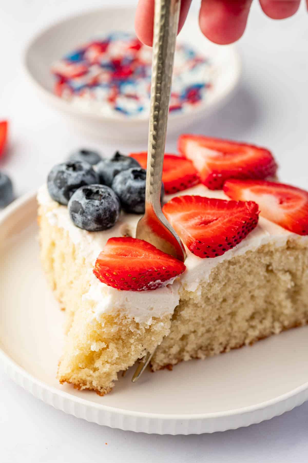 Close-up of flag cake a fork taking a bite.