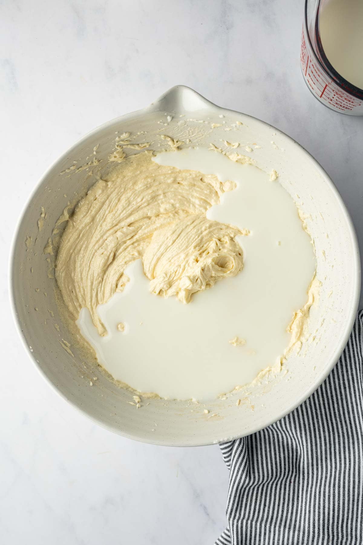 Adding buttermilk to the cake batter.