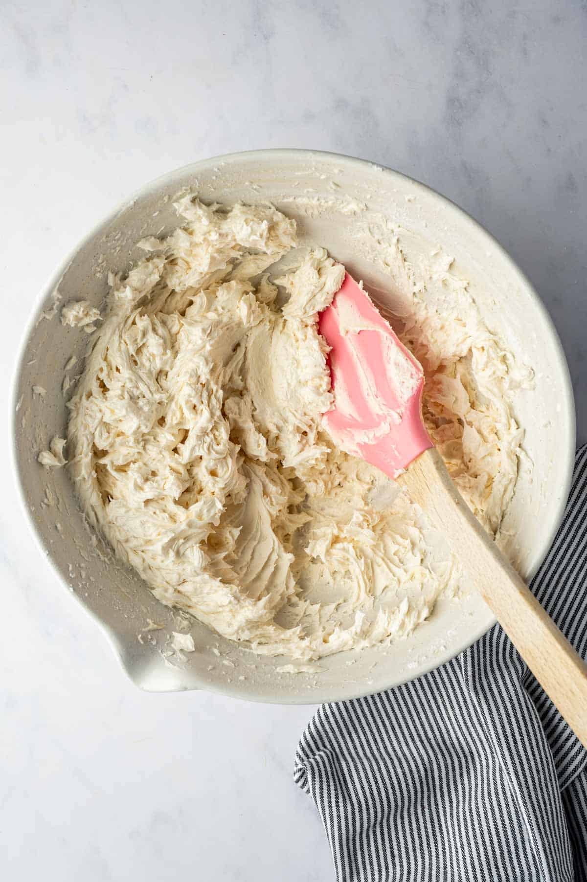 Vanilla buttercream in a bowl with a spatula