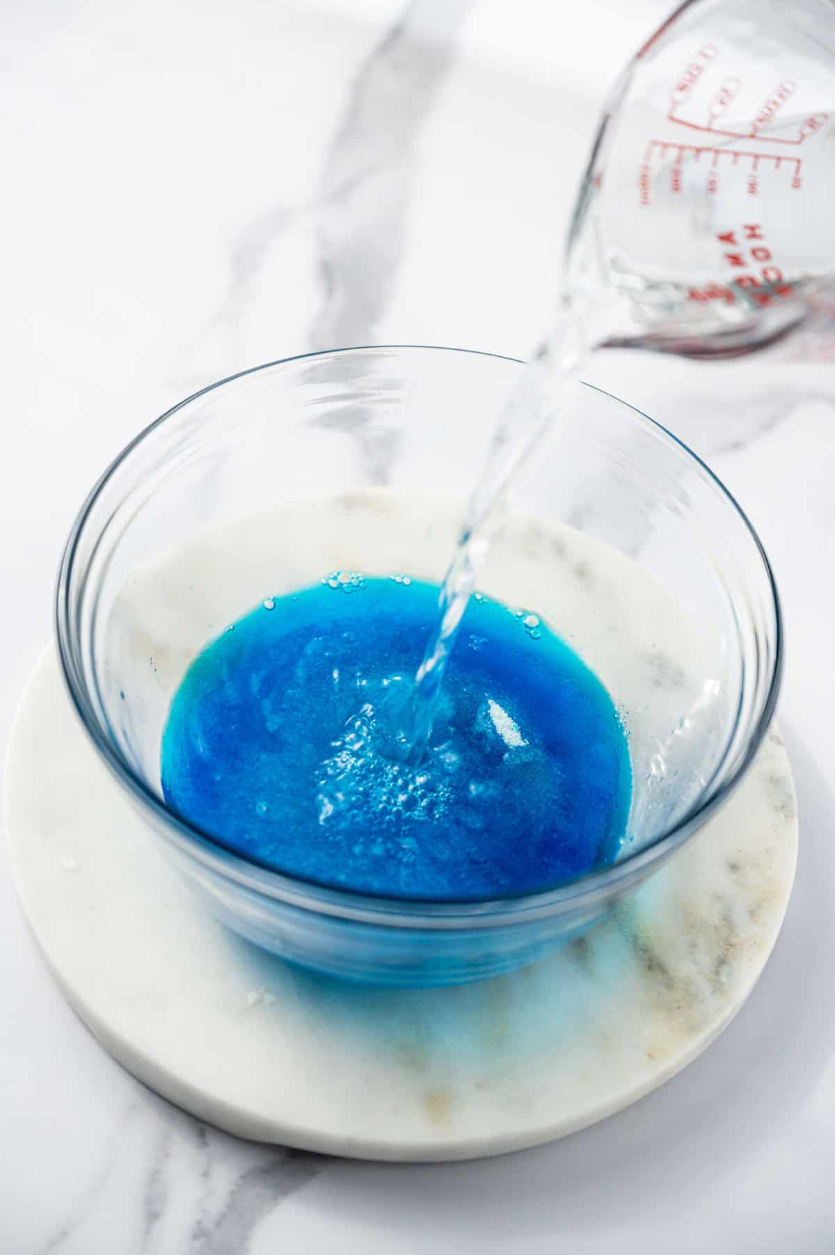 Blue Jello being added to the bowl