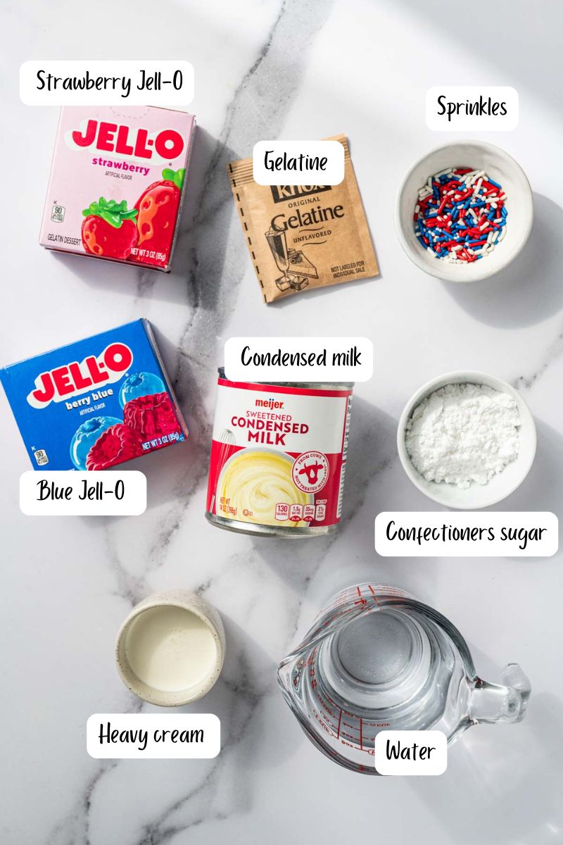 Ingredients laid out for making Fourth of july dessert table featuring colorful layered jello shots