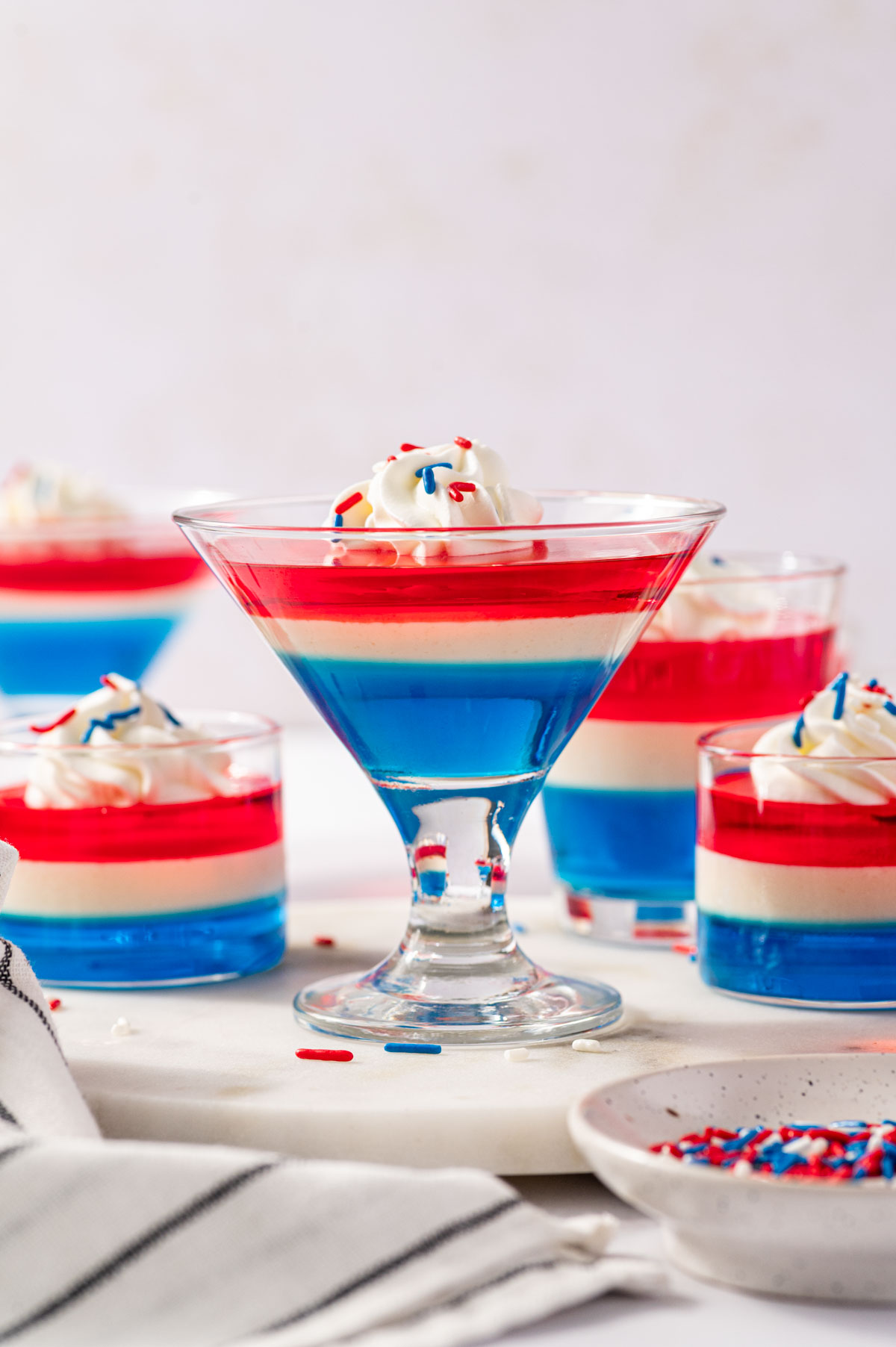 Fourth of July Jello shots with blue bottom layer, creamy white middle, and red top