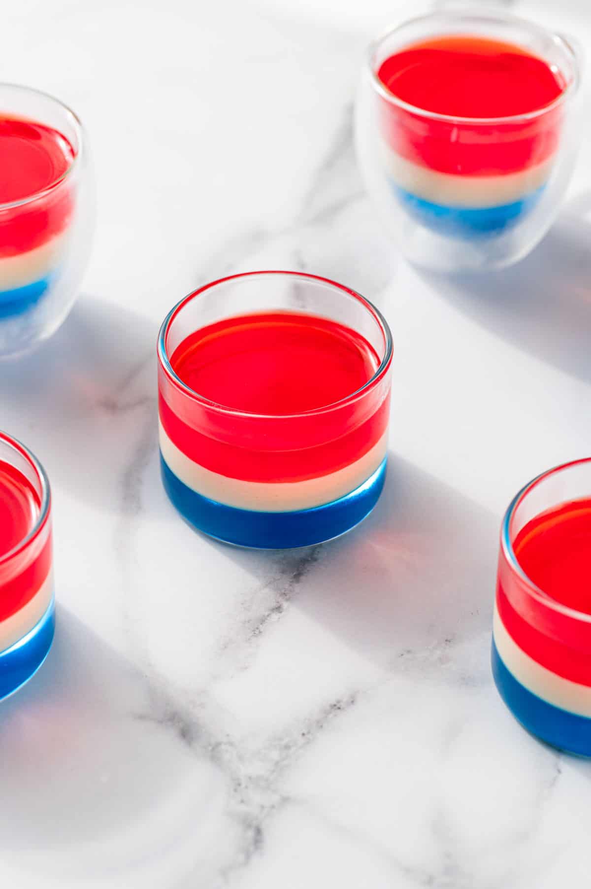 Red jello layer being added to the white layer