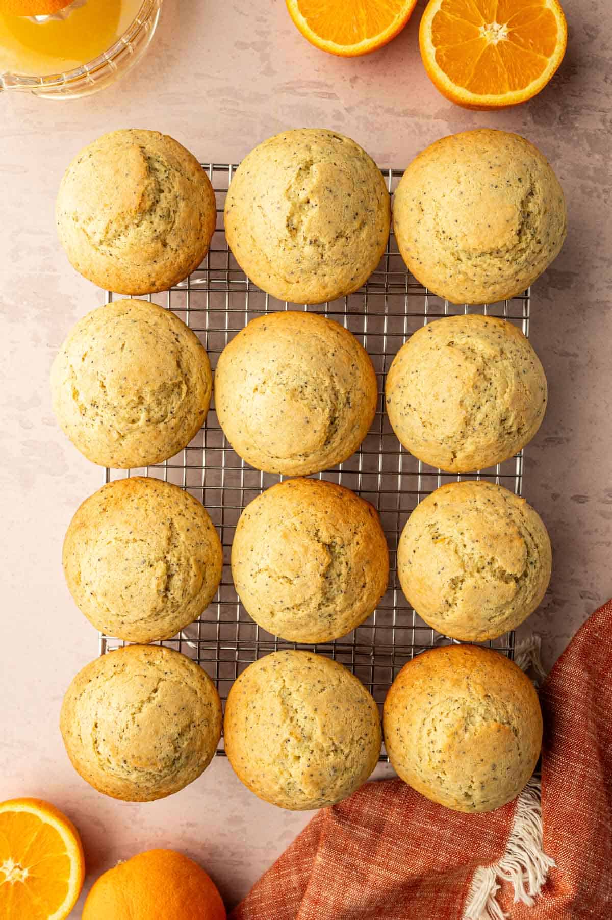 Orange poppy seed muffins on a cooling rack