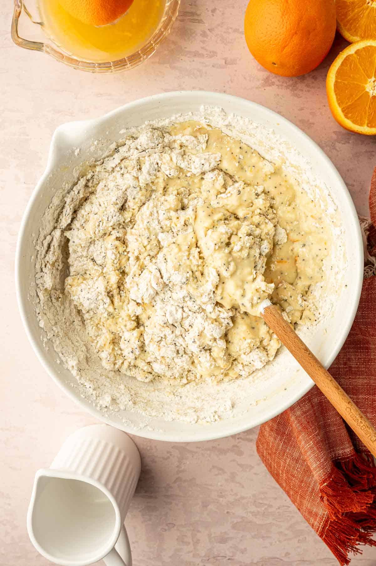 Orange muffin batter being mixed.