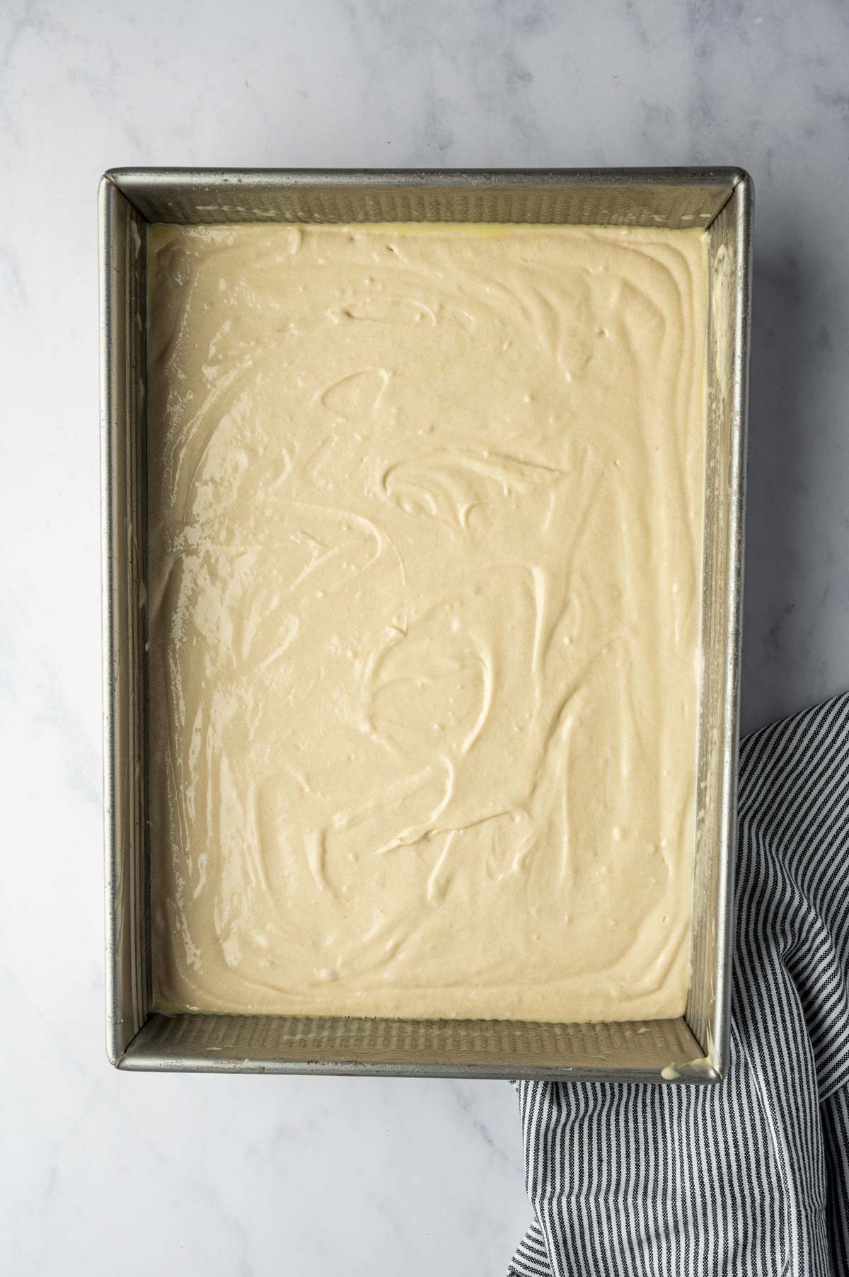Vanilla Cake Batter in a baking pan ready to bake.