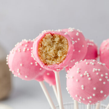 Inside of a birthday cake pop showing moist vanilla cake and frosting mixture