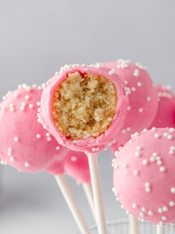 Inside of a birthday cake pop showing moist vanilla cake and frosting mixture