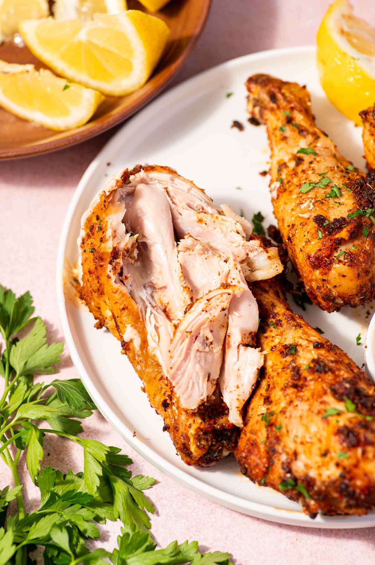 Close-up of crispy air fryer chicken drumsticks showing inside texture.