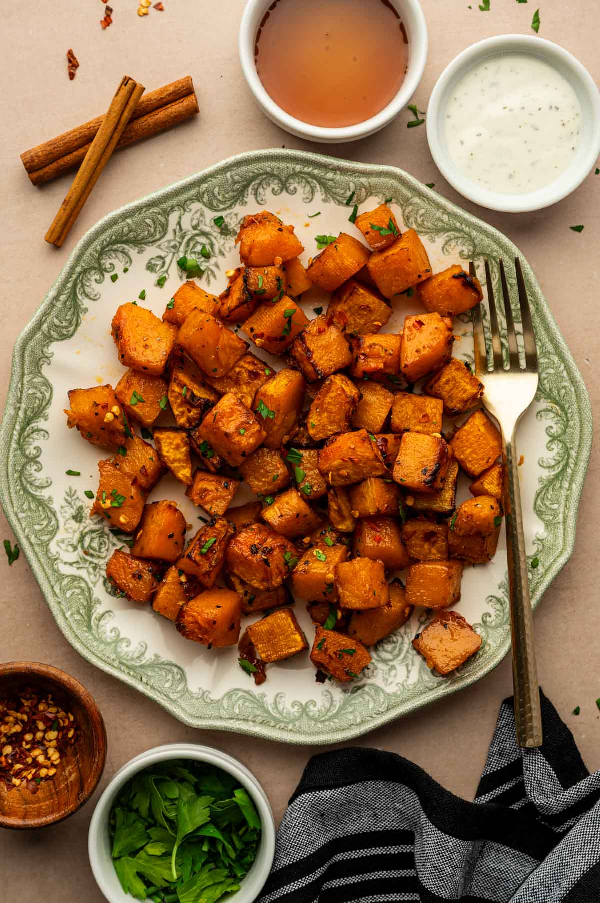 Golden Air Fryer Butternut Squash cubes cooked until tender and lightly crisp served in a plate.