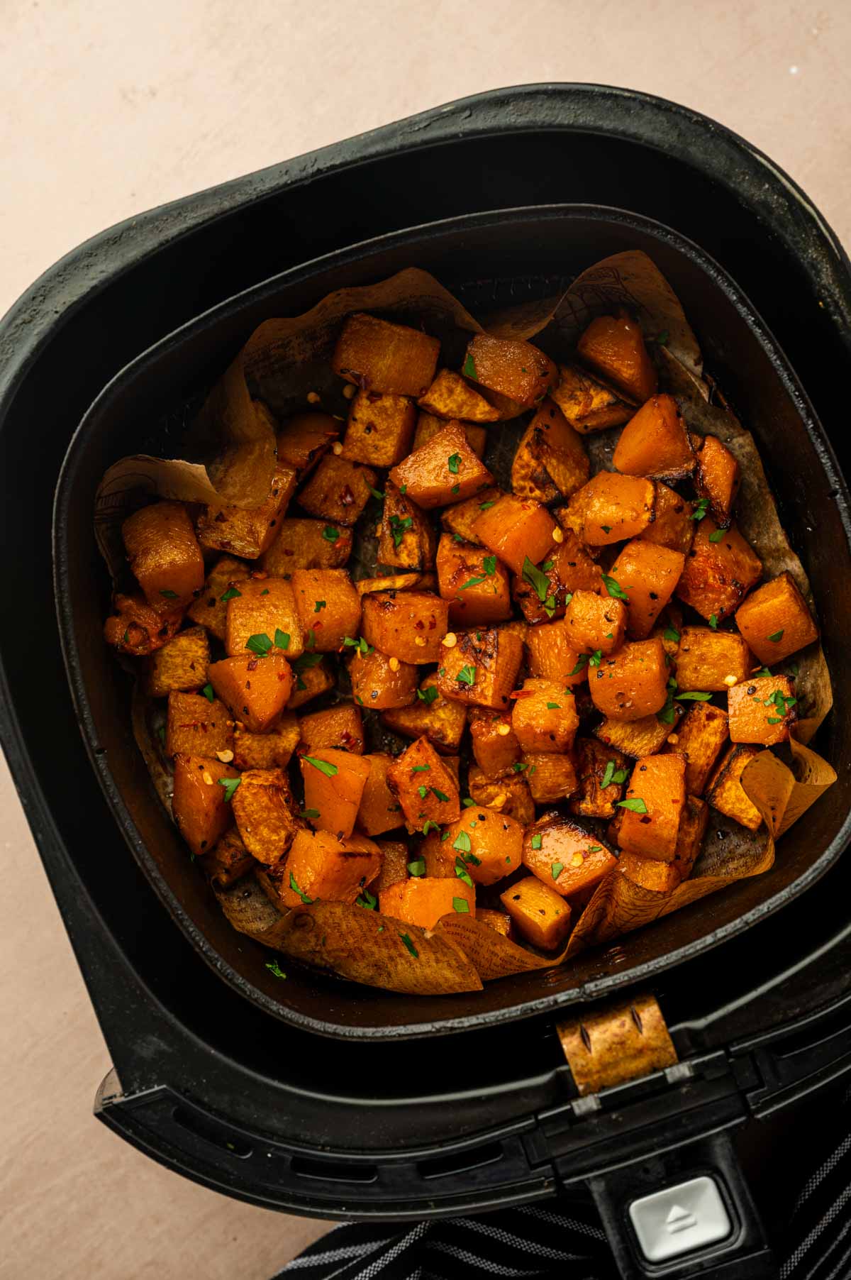 Cooked Air Fryer Butternut Squash garnished with fresh parsley and ready to serve.