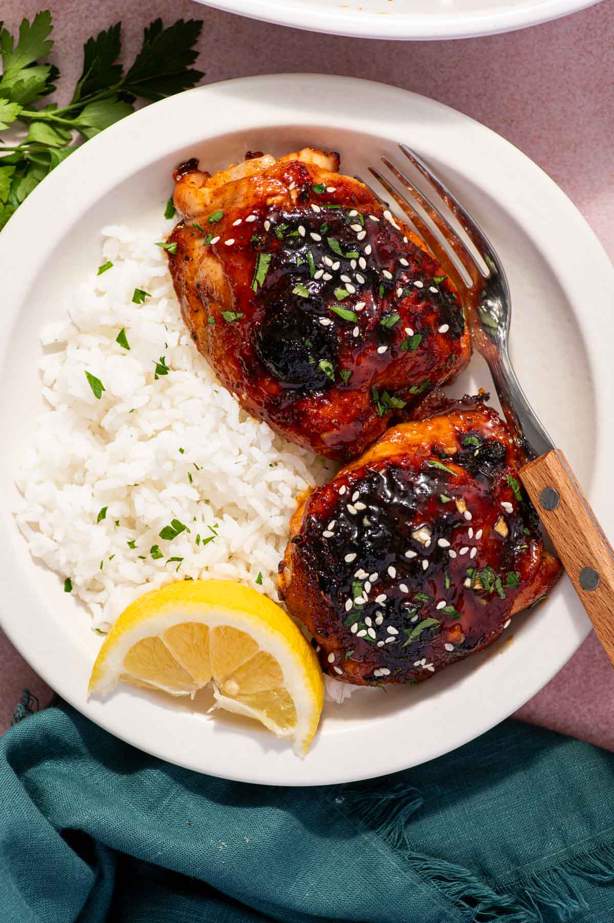 Baked honey garlic chicken thighs with rice.