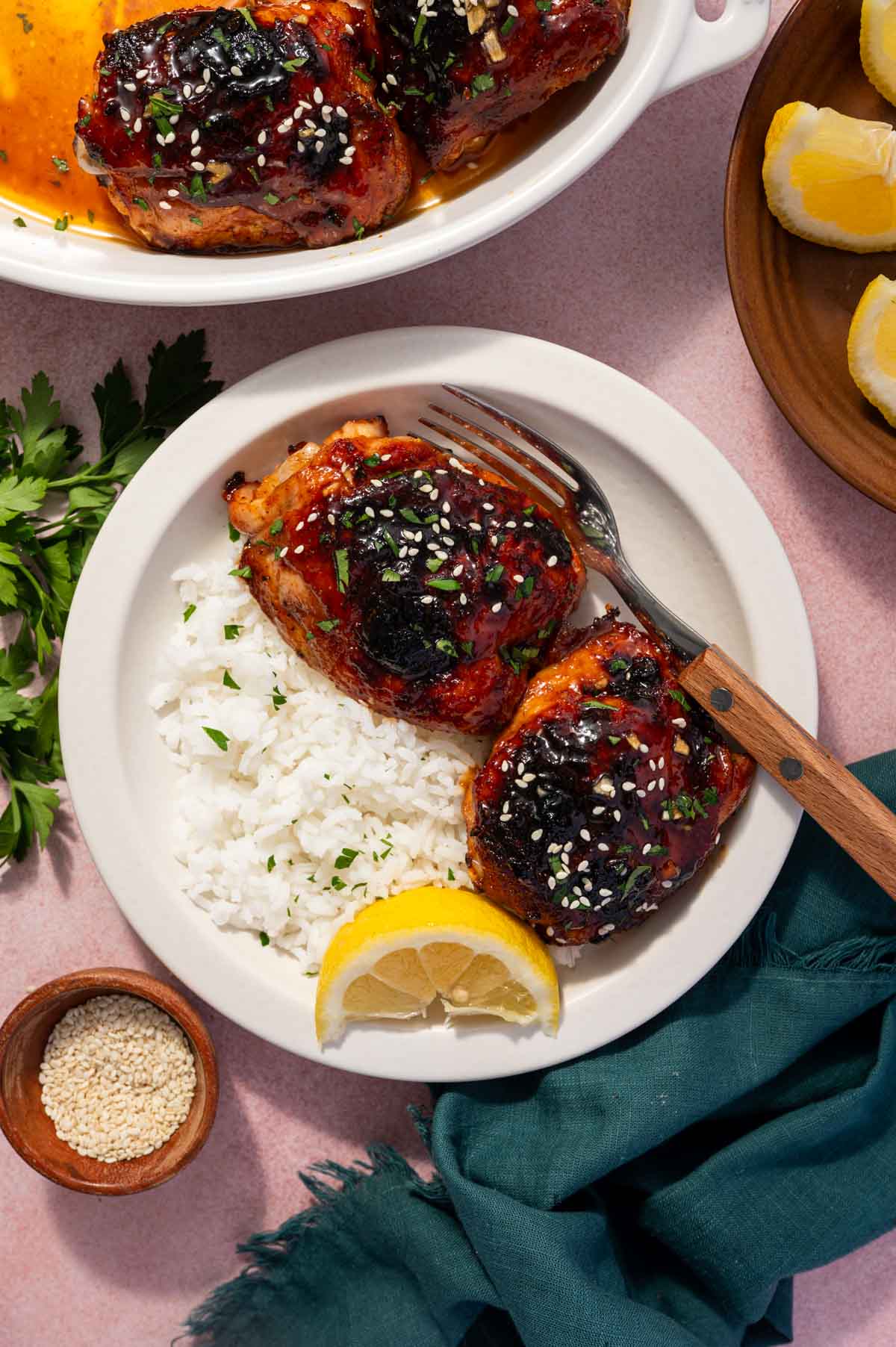 Tender baked chicken thighs coated in honey garlic glaze served with white rice