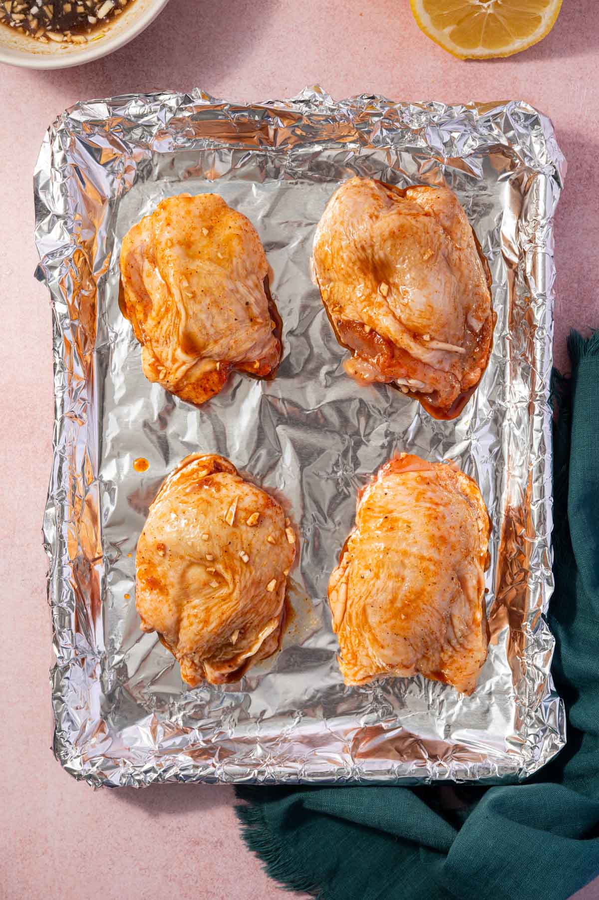 Chicken thighs arranged in a baking tray.