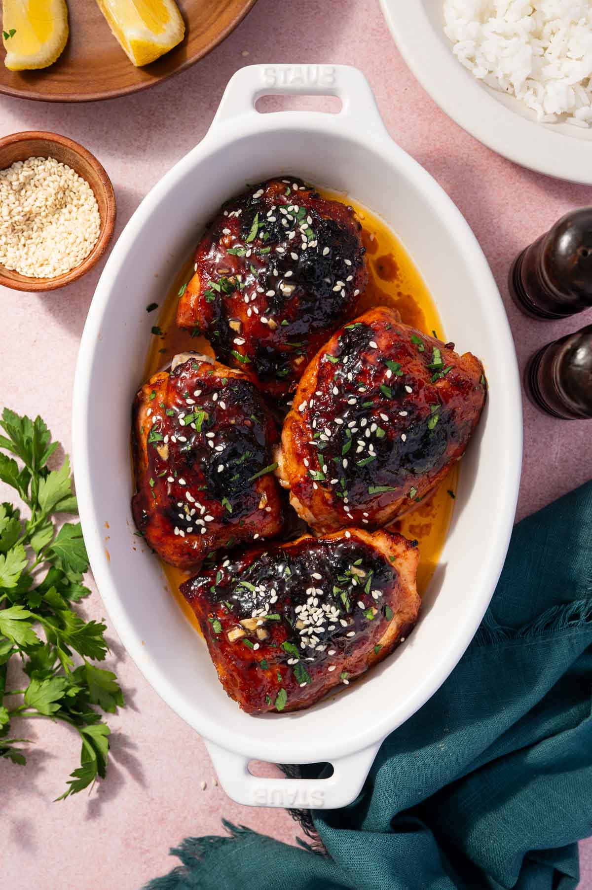 Golden brown honey garlic chicken thighs in a baking dish.