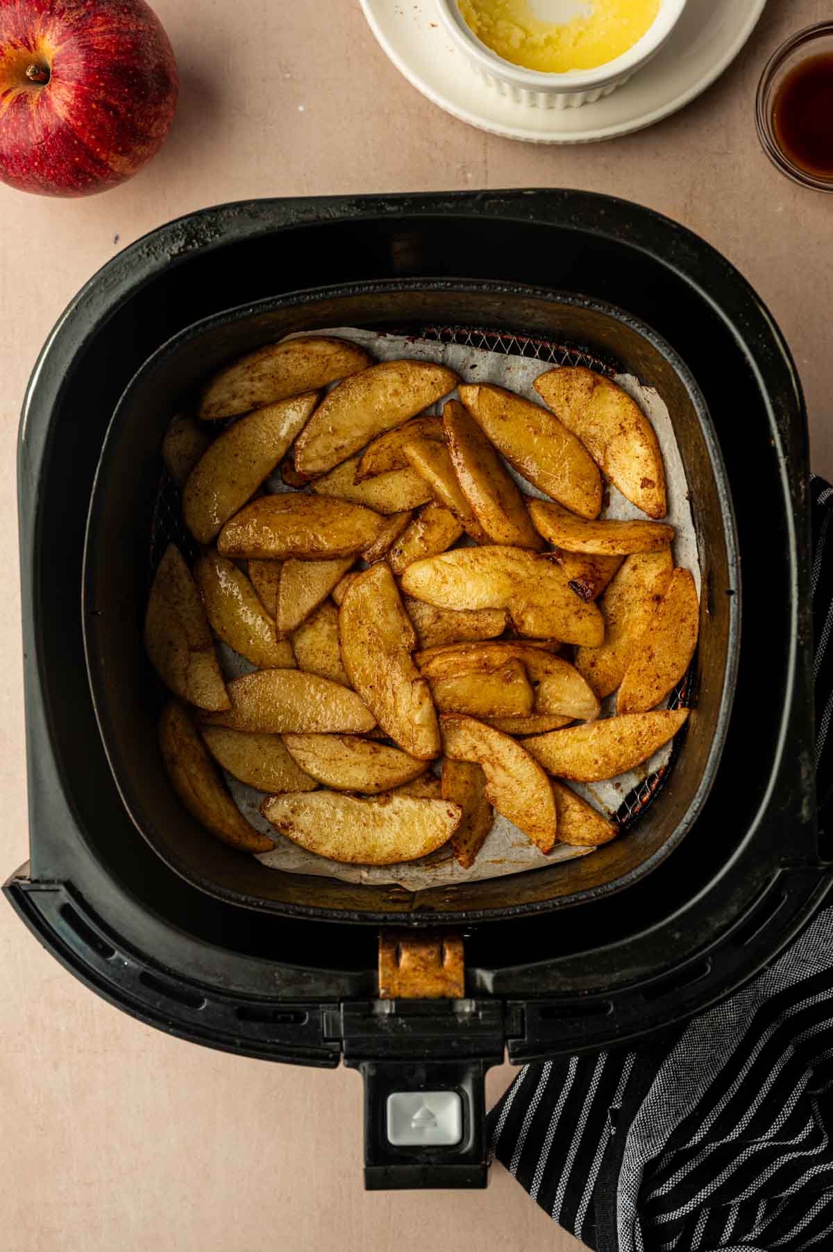 Cooked apple slices just out from the air fryer.