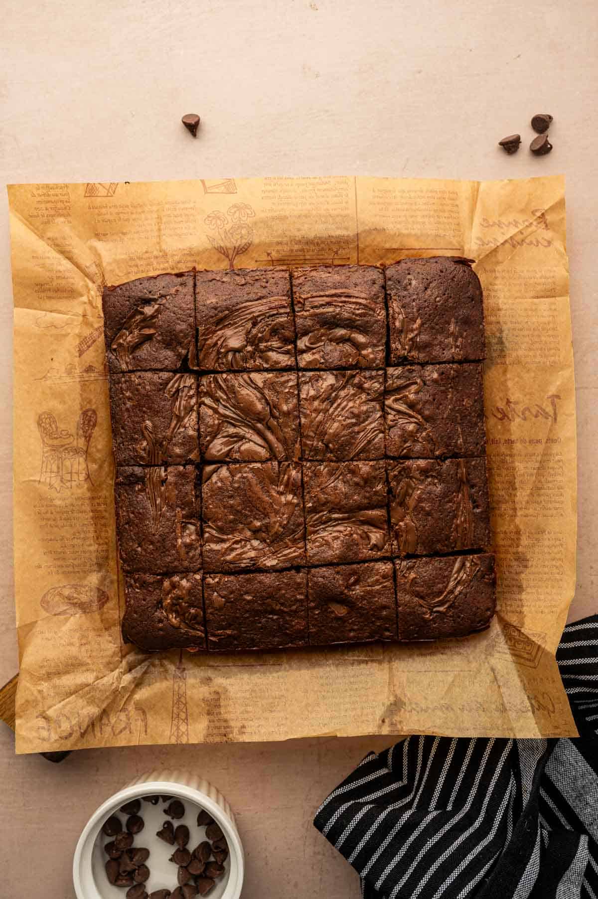 Nutella brownie squares with soft fudgy centers on a parchment paper