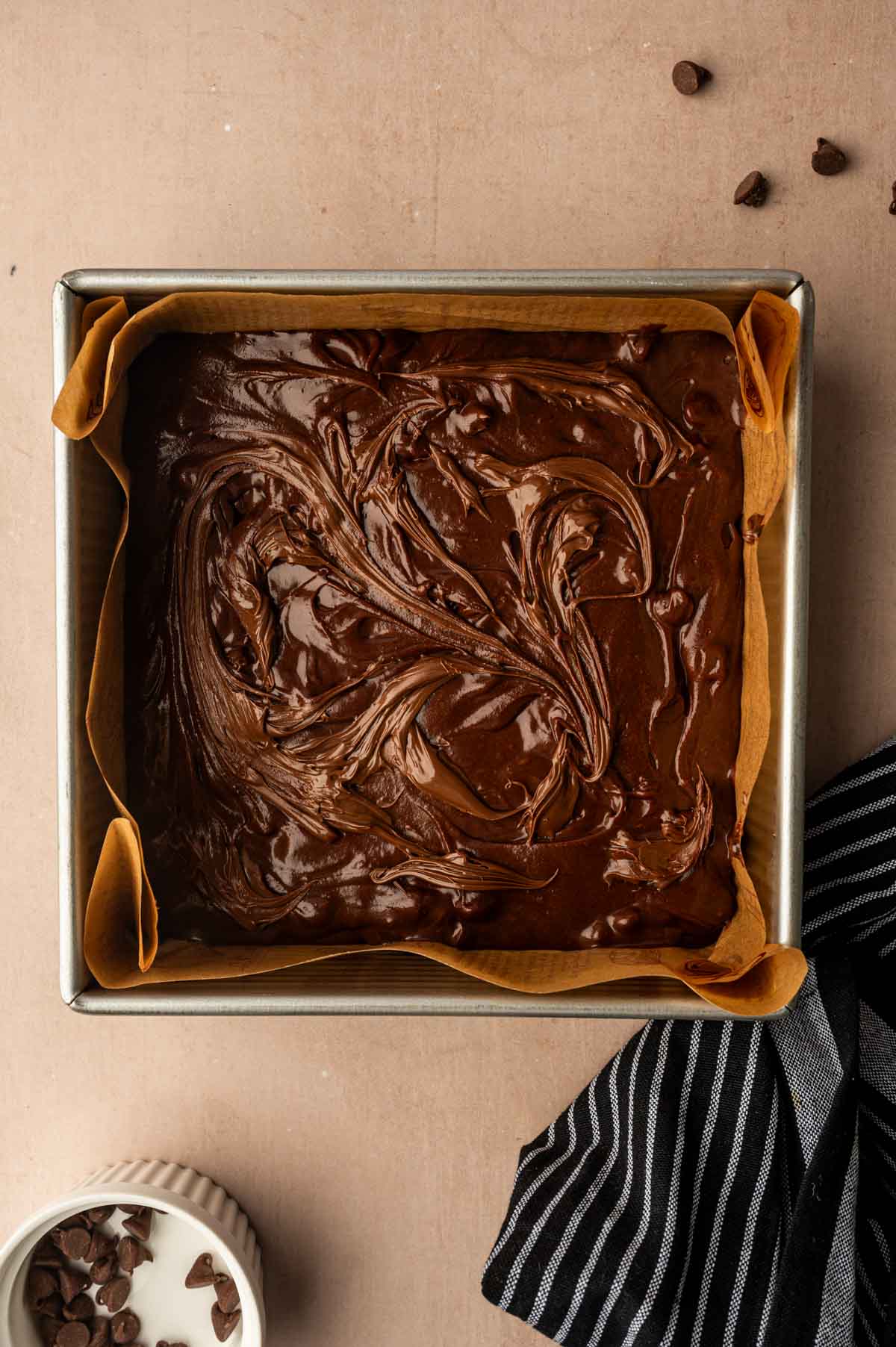 Nutella brownies ready to be baked placed in a square pan.