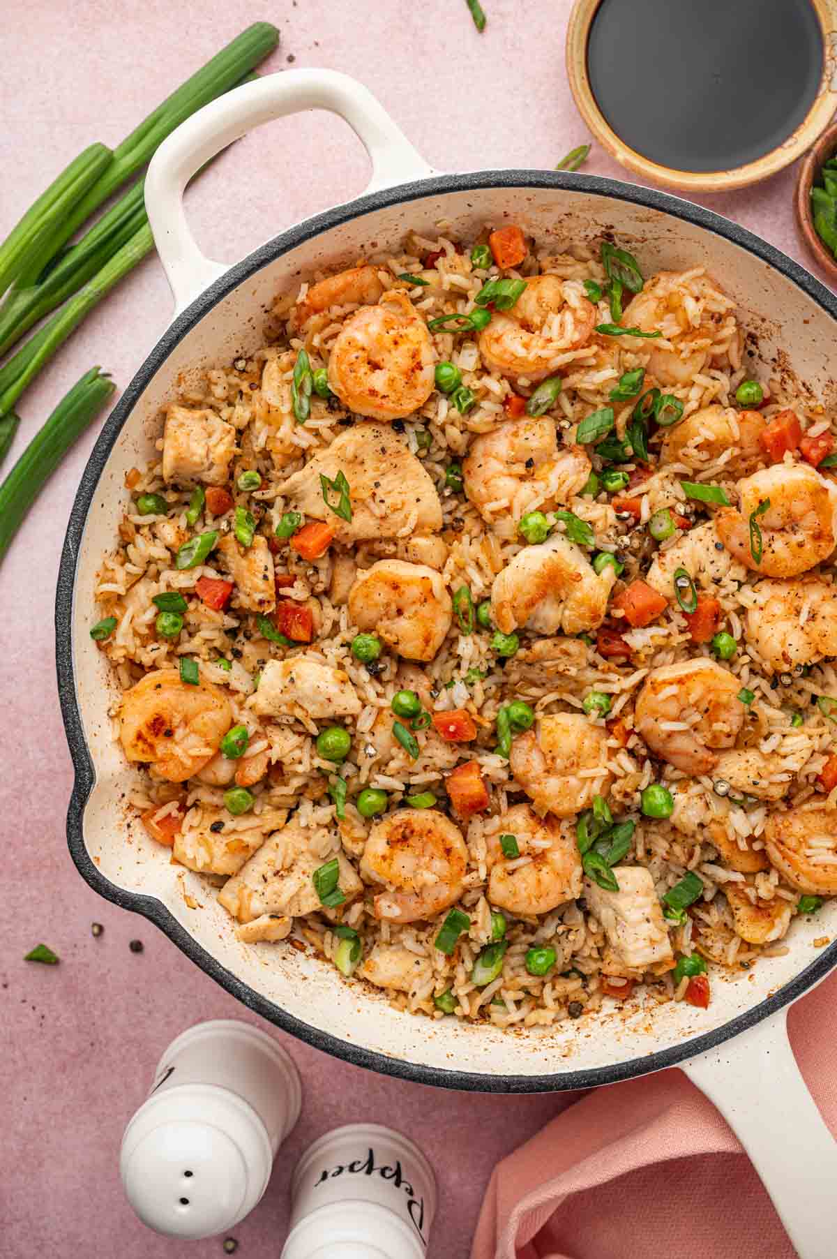 Chicken and shrimp fried rice served in a white skillet.
