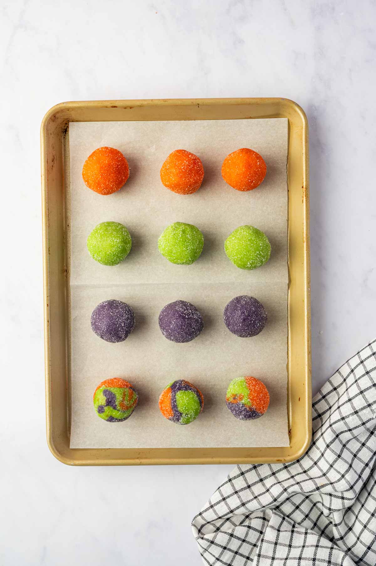 Halloween cookies are arranged on a baking tray and ready to be baked.