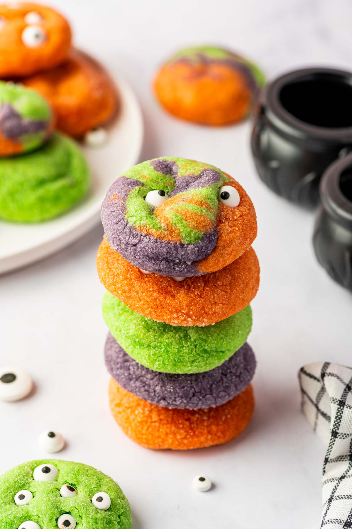 Stack of colorful Halloween Monster Eye Cookies in purple, orange, and green