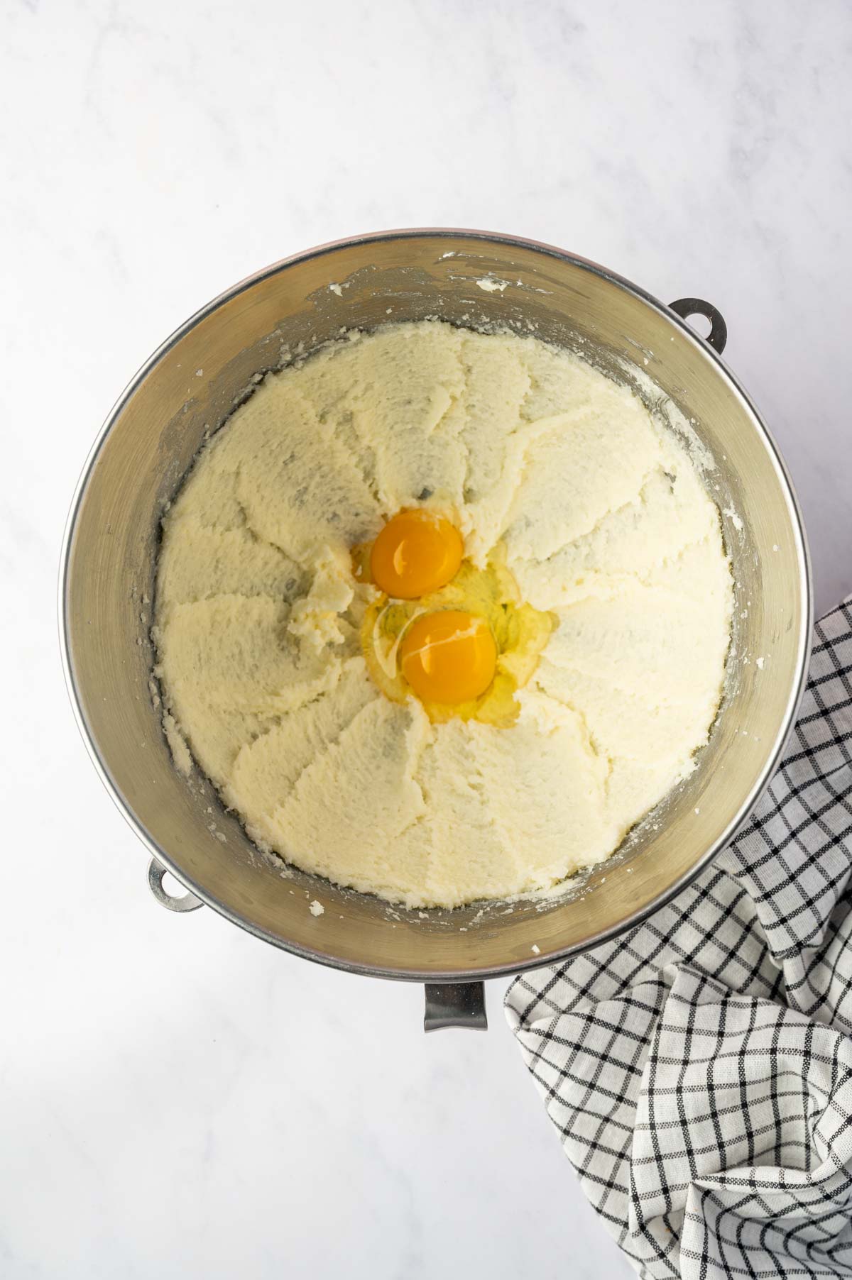Eggs being added to the butter and sugar mixture