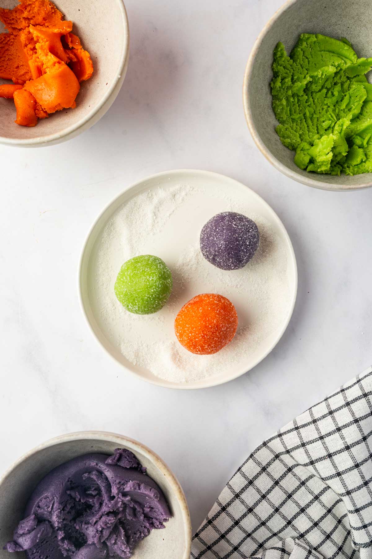 The cookie dough balls are coated in sugar