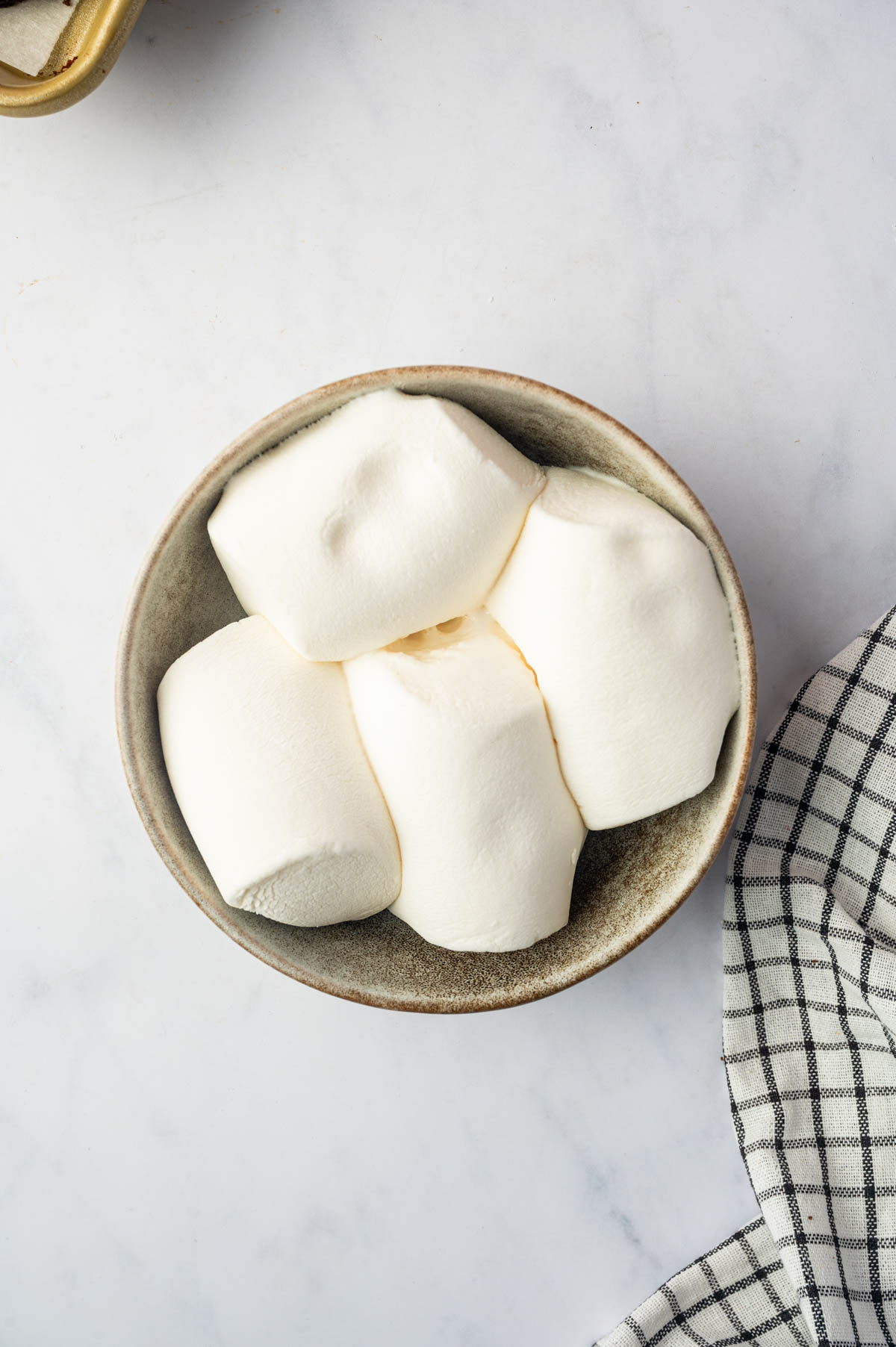 Melted marshmallows are placed in a bowl