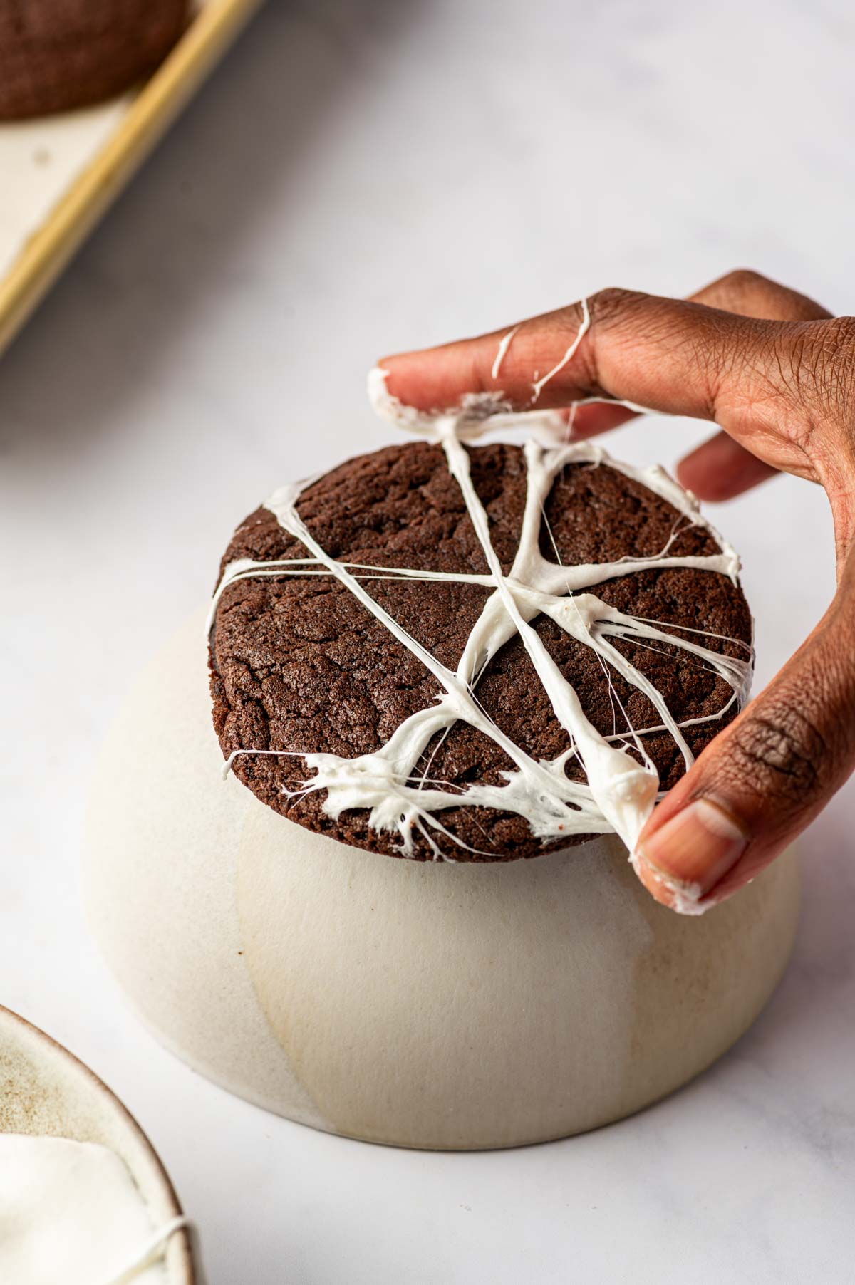 Melted marshmallows trying to for the spider web using finger tips