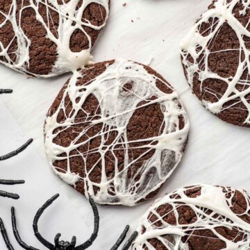 Halloween Spider Web Cookies with white marshmallow stretched over chocolate cookies