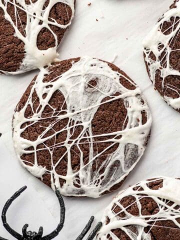 Halloween Spider Web Cookies with white marshmallow stretched over chocolate cookies